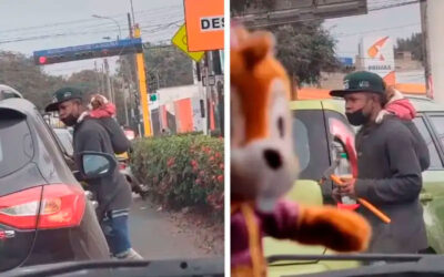 Jovem carrega seu cachorro nas costas enquanto limpa carros nas ruas para sobreviver